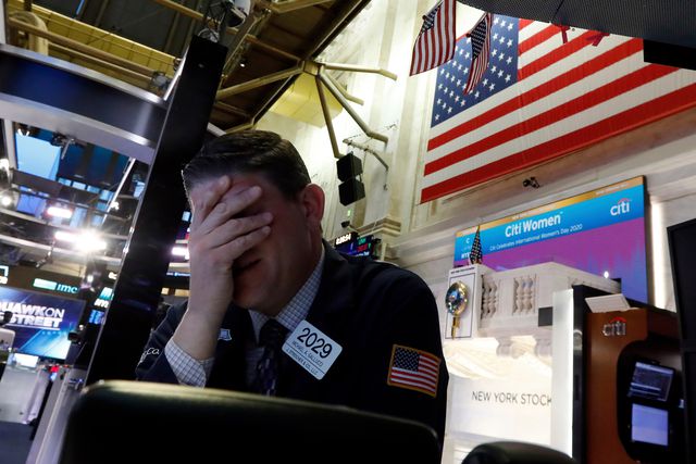 Trader Michael Gallucci prepares for the day's activity on the floor of the New York Stock Exchange.